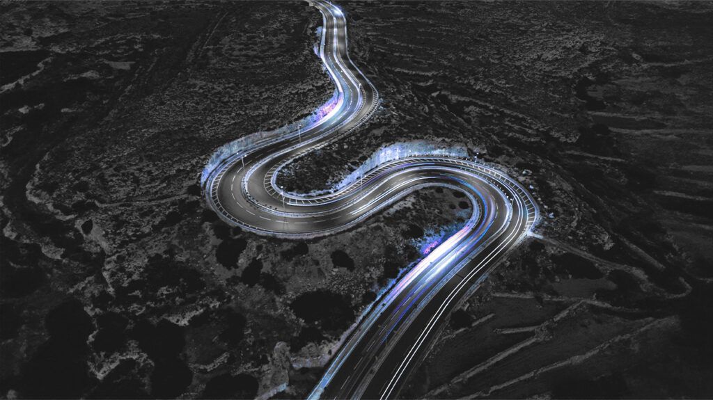 A curved road illuminated at night